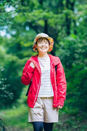 Young woman walking in the fresh green mountain