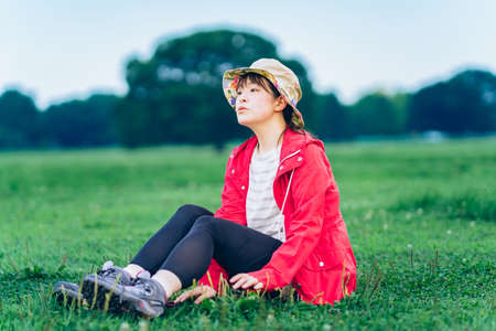 A young woman with a relaxed look on the meadowの写真素材