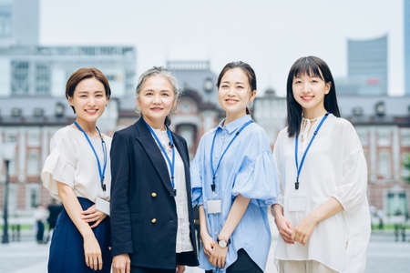 Business women of various generations outdoors