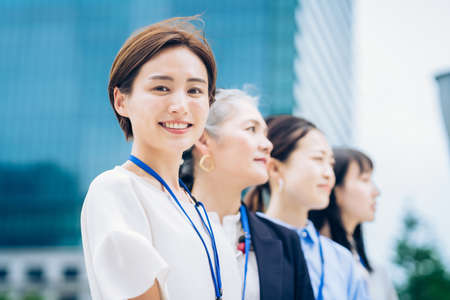 Asian business women lined up outdoors