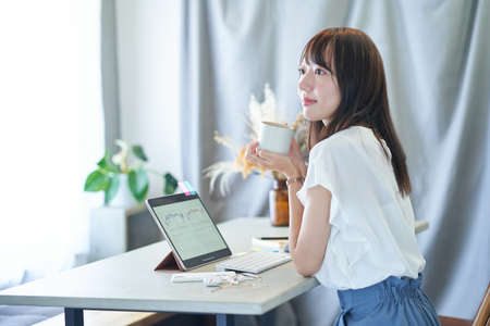 Young woman relaxing and working in her room