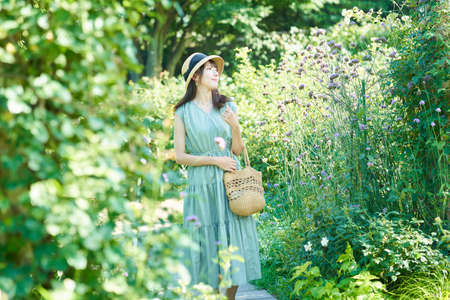 young woman walking in green on fine day