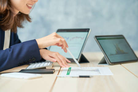 Business woman giving a presentation using reference materials