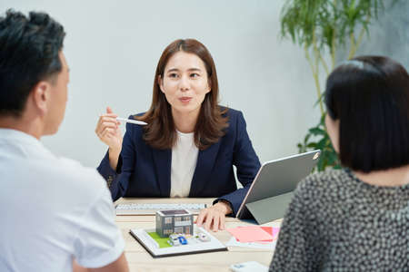Young woman in a suit who sells real estate