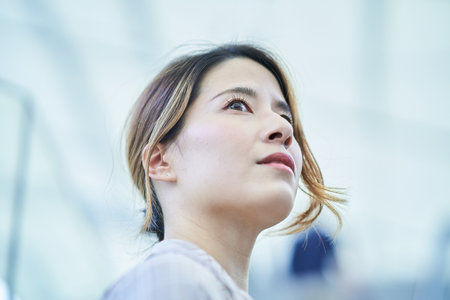 portrait of asian woman outdoors on fine dayの写真素材