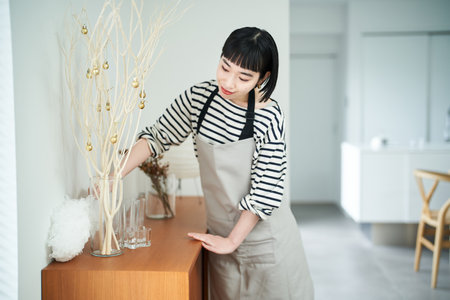 asian young woman cleaning the roomの写真素材