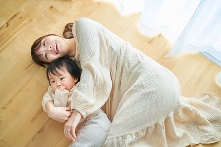 mother and child hugging in the roomの写真素材
