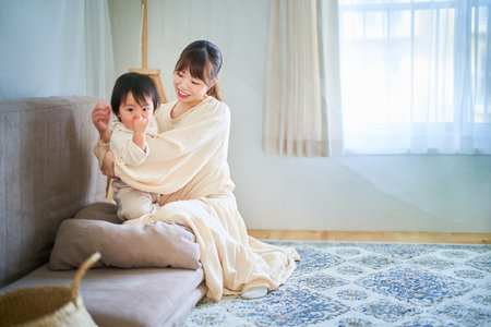 mother and child hugging in the roomの写真素材