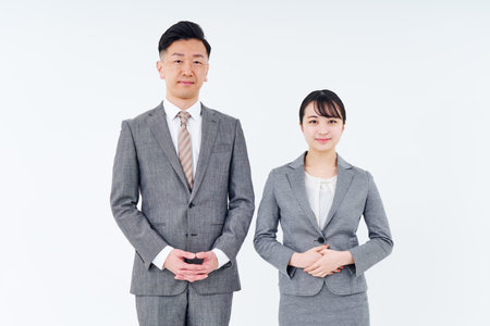 man and woman in suits and white backgroundの写真素材