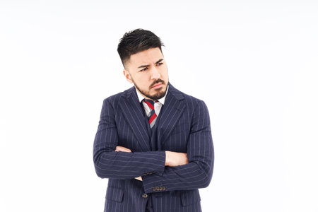 A man in a suit posing in thought and white backgroundの写真素材