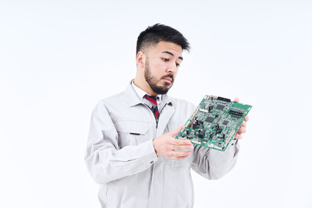 A man in work clothes with a computer board  and white backgroundの写真素材