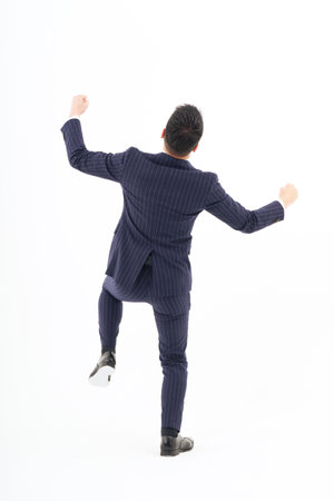 A man in a suit expressing joy and white backgroundの写真素材