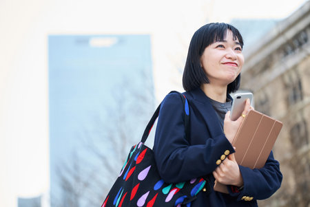 A young woman commuting to work or going out on a fine dayの写真素材