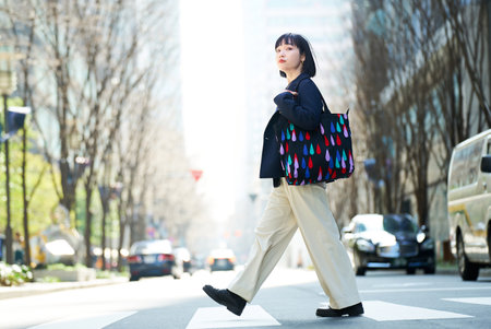 A young woman commuting to work or going out on a fine dayの写真素材