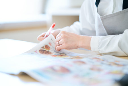Woman looking at grocery advertisement in the roomの写真素材