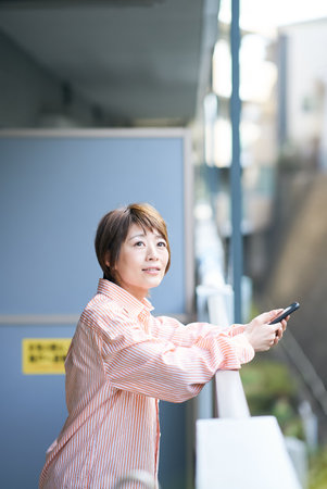 Asian woman resting on the verandaの写真素材