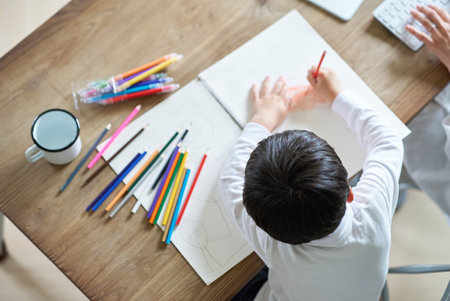 A mother working in her room and a child drawingの写真素材