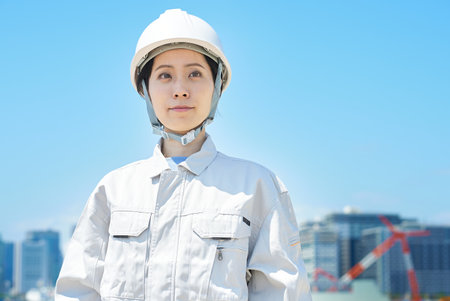 A woman wearing a helmet and wearing work clothes on fine day