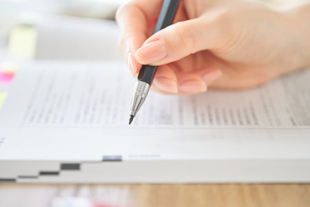 close up of a woman's hand studying with textの写真素材