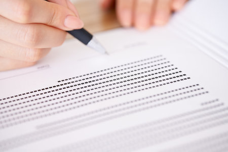 Woman's hand signing a document with a pen
