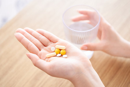 hand of woman with medicine in the roomの写真素材