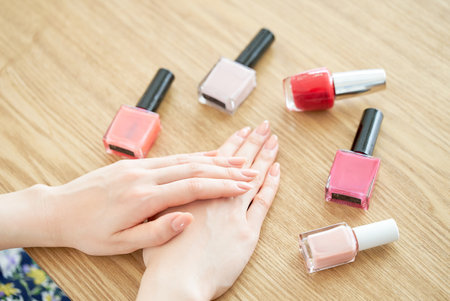 Nail bottle and woman's hand in the roomの写真素材