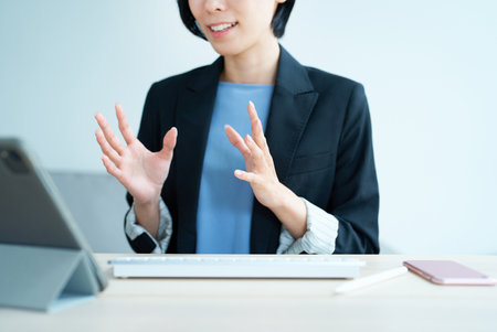 Businesswoman using tablet pc for online communication in the room
