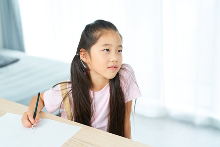A girl who opens a notebook and listens to teacherの写真素材