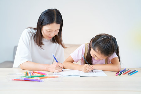 Parent and child playing and drawing in the roomの写真素材
