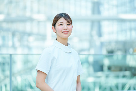 portrait of working woman in white coatの写真素材
