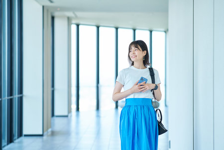 portrait of a young woman by the windowの写真素材