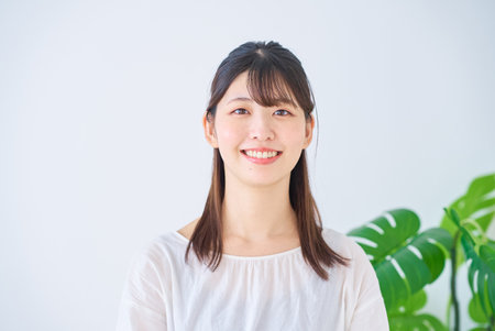 Portrait of a smiling young woman indoorsの写真素材