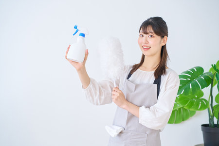 young woman with cleaning tools indoors