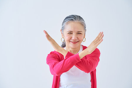 Senior woman giving a no sign indoorsの写真素材