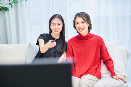 two women watching tv in the room