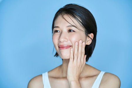 A middle aged woman checking her skin conditionの写真素材