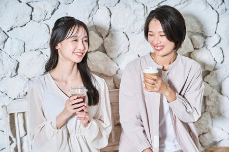 Women having fun talking while drinking coffee