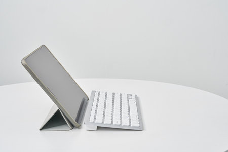Close-up of wireless keyboard from the side on a white tableの写真素材