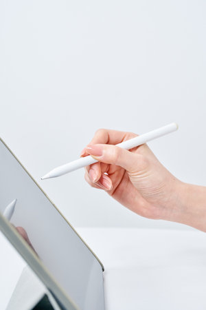 Hand of a woman operating a stylus penの写真素材