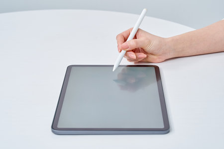Hand of a woman operating a stylus penの写真素材
