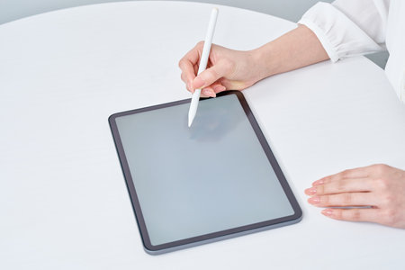 Hand of a woman operating a stylus penの写真素材