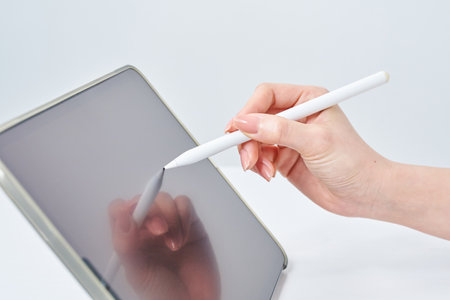 Hand of a woman operating a stylus penの写真素材