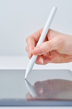 Hand of a woman operating a stylus penの写真素材
