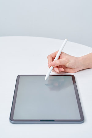 Hand of a woman operating a stylus penの写真素材
