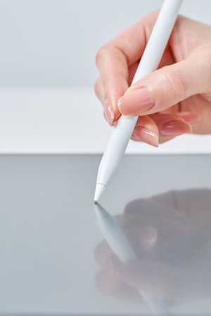 Hand of a woman operating a stylus penの写真素材