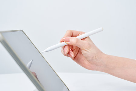 Hand of a woman operating a stylus penの写真素材