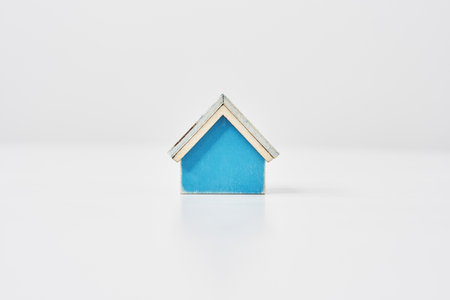 Blue house model placed on a white tableの写真素材