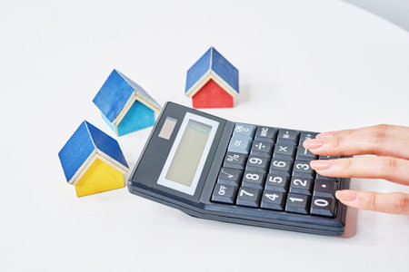 Colorful house models and calculator on the talbeの写真素材