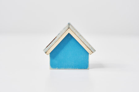 Blue house model placed on a white tableの写真素材