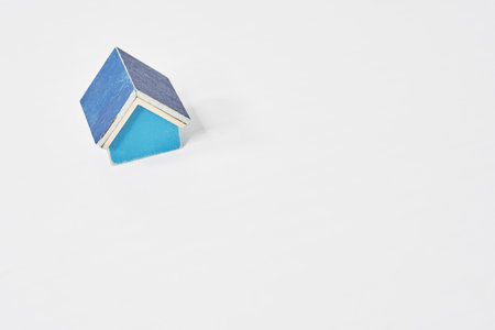 Blue house model placed on a white tableの写真素材